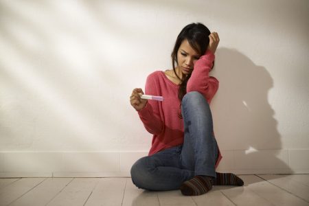Women and health, anxious girl looking at pregnancy test kit
